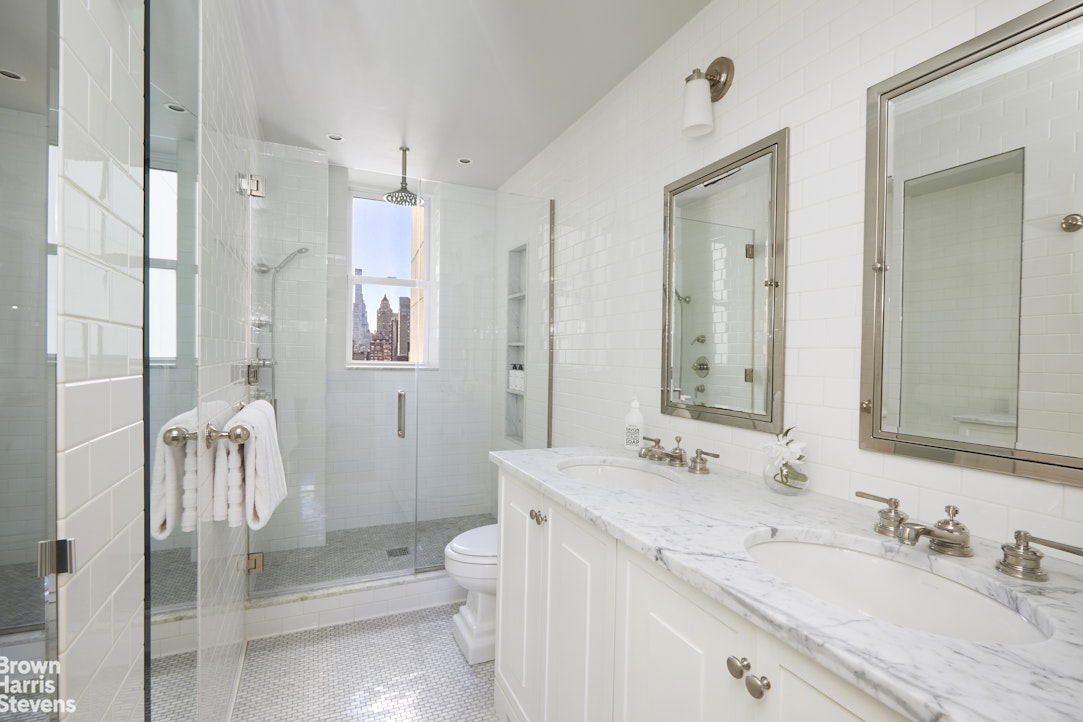 64 East 86th Street, Unit 12AB Manhattan, NY 10028 - Photo 8 of 15 a bathroom with a sink a toilet and shower