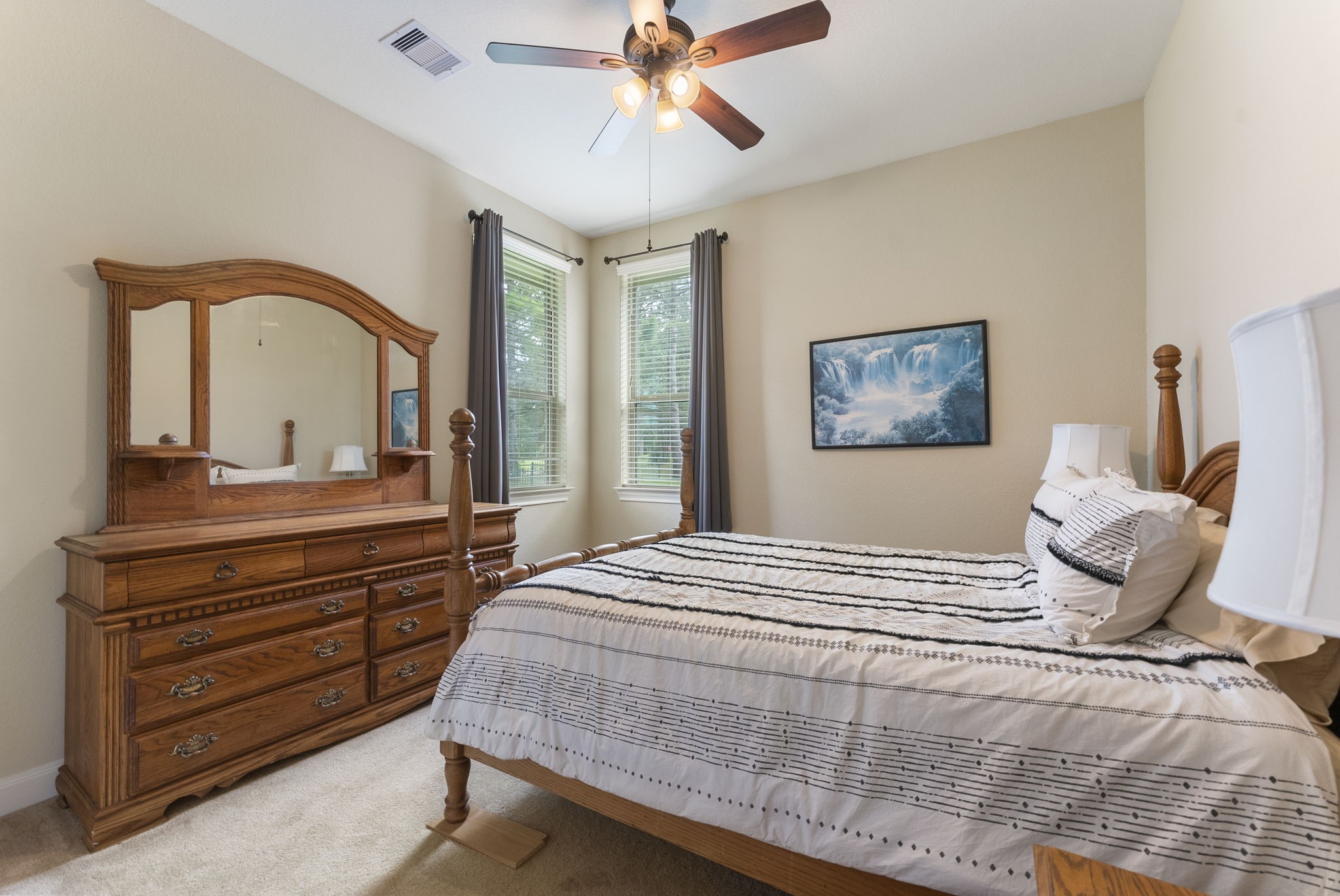 4787 Jackson Square Drive Conroe, TX 77304 - Photo 27 of 35 Wake up to a view that feels like a dream! This spacious secondary bedroom, offers a front-row seat to the rolling greens of the nearby golf course. With its generous layout and serene ambiance, it’s perfect as a luxurious second primary bedroom—ideal for multi-generational living or anyone needing two primary retreats.