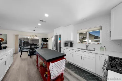 a kitchen with stainless steel appliances a stove sink and cabinets
