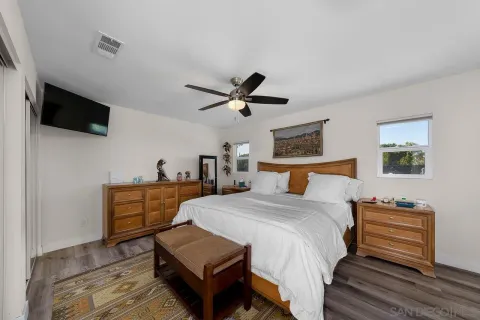 a bed room with a bed and a television