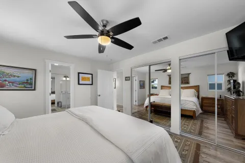 a bedroom with a bed and wooden floor