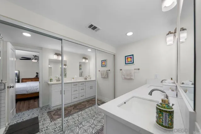 a bathroom with a tub sink and mirror