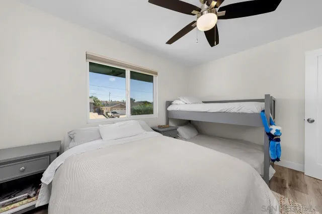 a bedroom with a bed and a ceiling fan