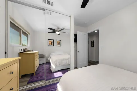 a bedroom with bed and wooden floor