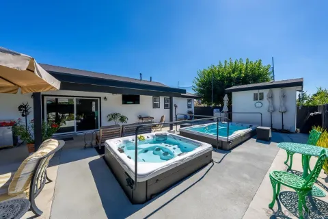 a view of house with backyard and furniture