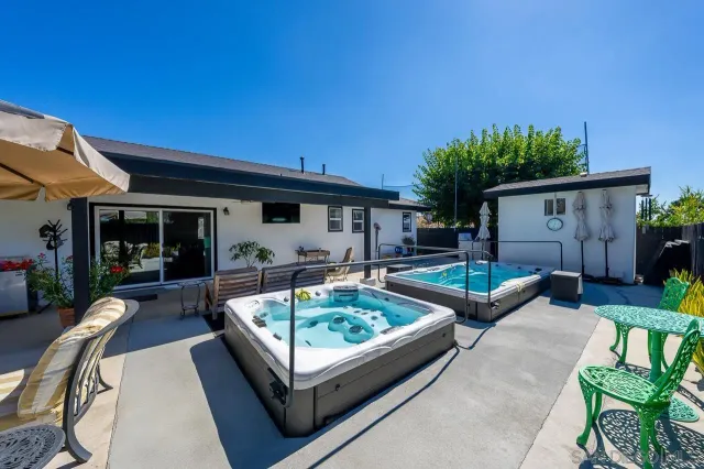 a view of house with backyard and furniture