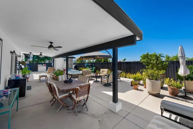 a view of a patio with chairs and potted plants