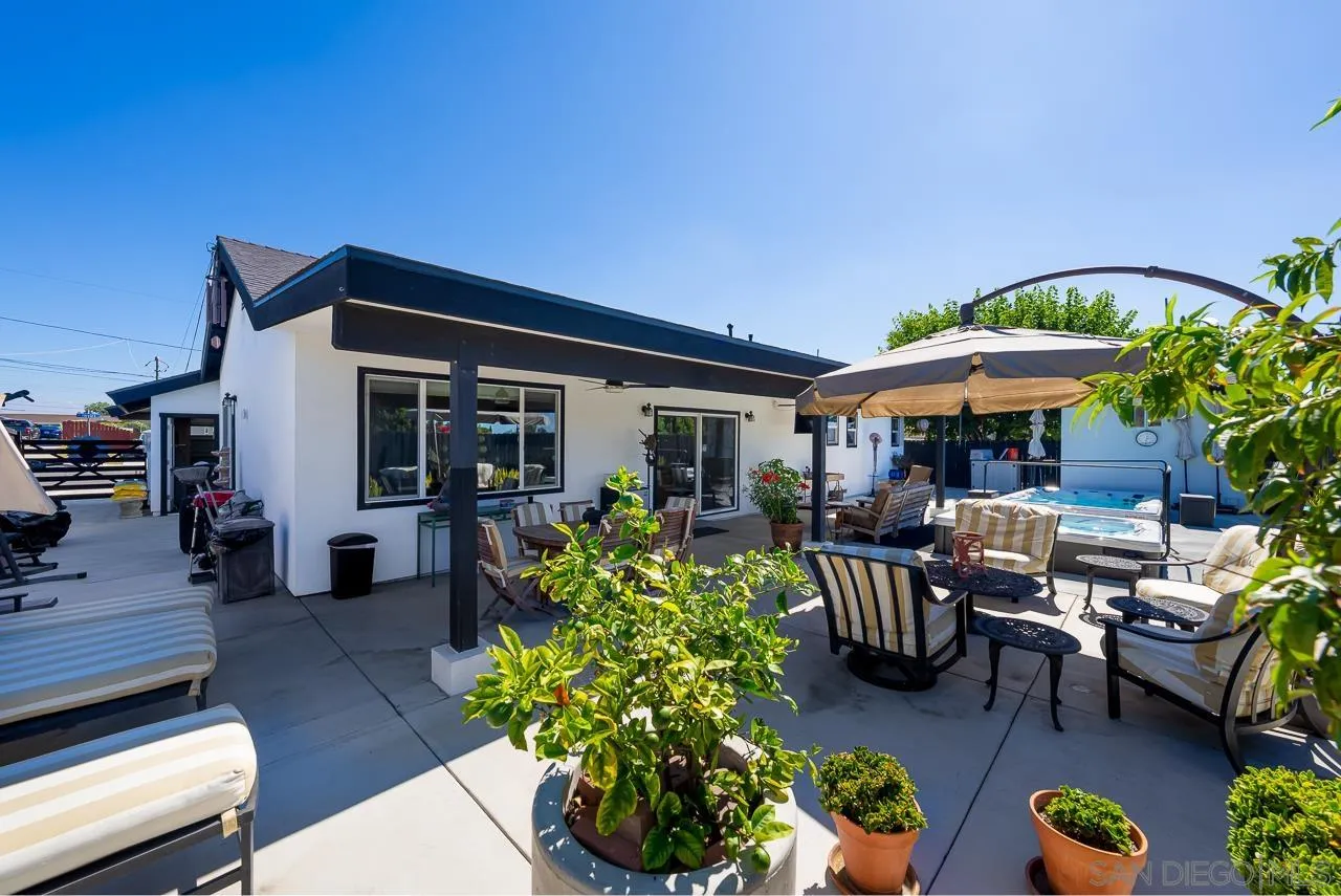 1761 Harvard Street Chula Vista, CA 91913 - Photo 31 of 41 a patio with a table and chairs under an umbrella