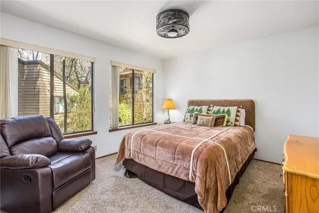 a bedroom with bed and a couch