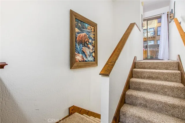 a view of staircase with white walls and a window