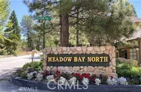 a street sign on a sidewalk next to a road