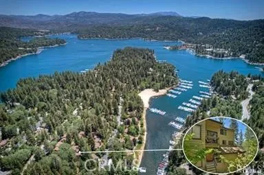an aerial view of a house with garden space and a lake view