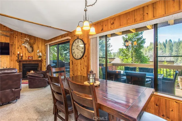 a living room with furniture a fireplace and a floor to ceiling window