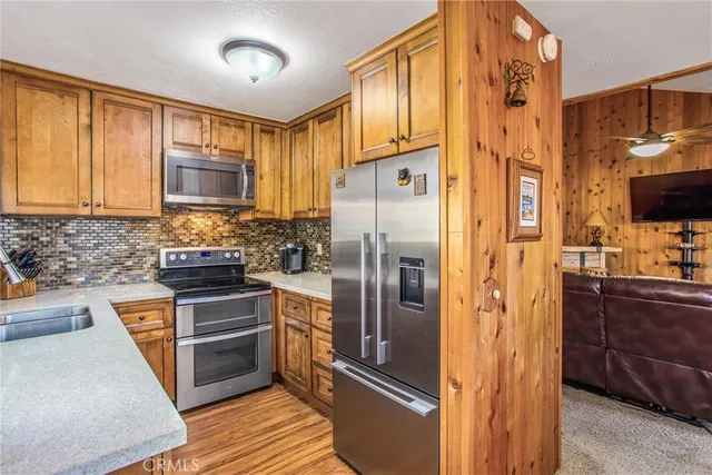 a kitchen with stainless steel appliances granite countertop a refrigerator stove and sink