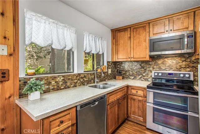 a kitchen with a sink stove and microwave