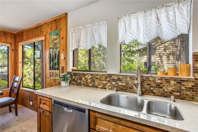 a kitchen with a sink and a large window