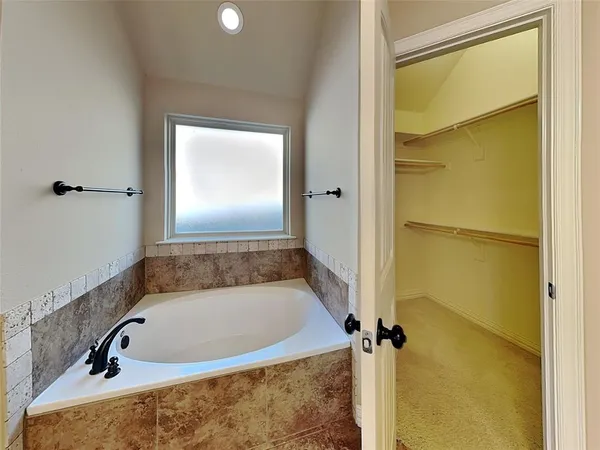 a bathroom with a tub and a shower