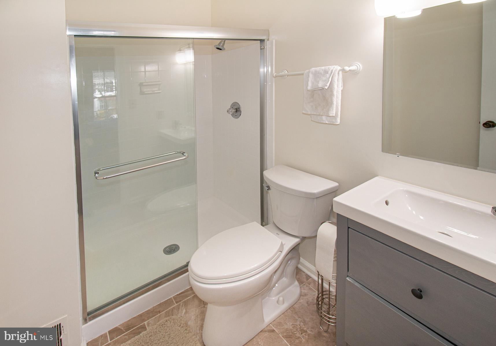 5619 Ridge View Drive Alexandria, VA 22310 - Photo 23 of 36 Gleaming shower ,new glass door, vanity & floor