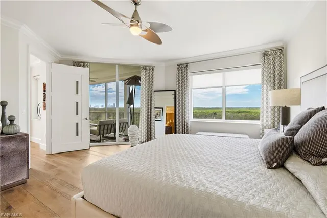 a bedroom with a large bed and a large window