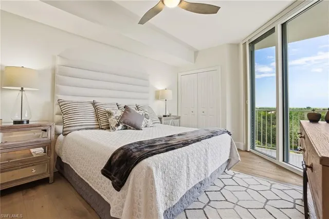 a bedroom with bed tv and a window