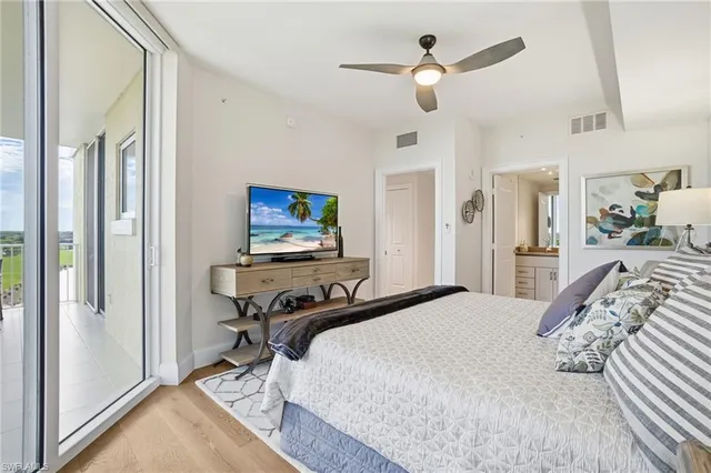a living room with furniture a large window and a table