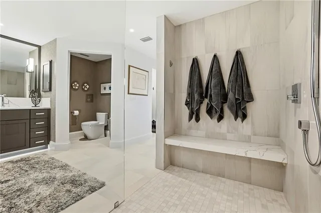 a bathroom with a sink a toilet and mirror