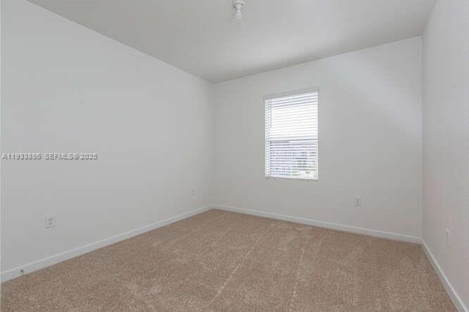 1780 Southeast 9th Avenue Homestead, FL 33034 - Photo 18 of 20 an empty room with a window