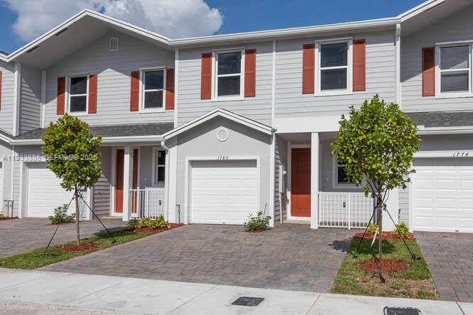 1780 Southeast 9th Avenue Homestead, FL 33034 - Photo 2 of 20 a front view of a house with a yard and garage