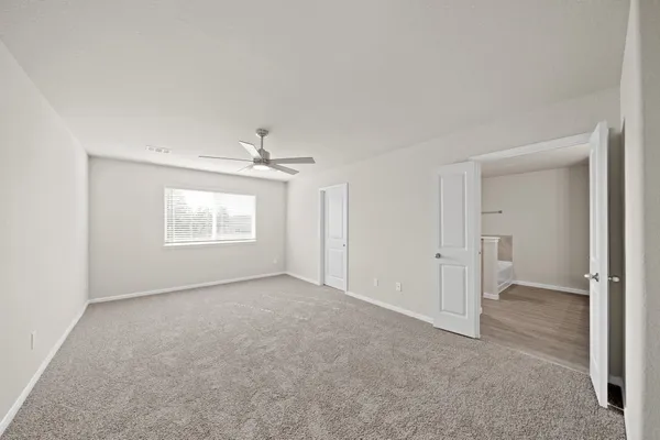 an empty room with windows and closet