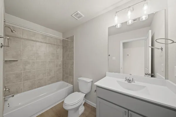 a bathroom with a sink a toilet and a bathtub