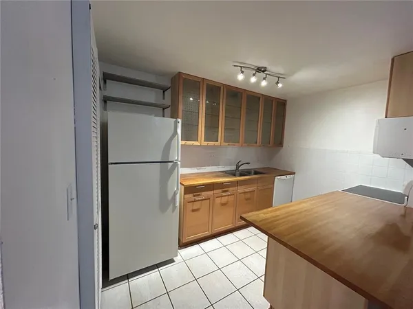 a kitchen with a refrigerator and cabinets