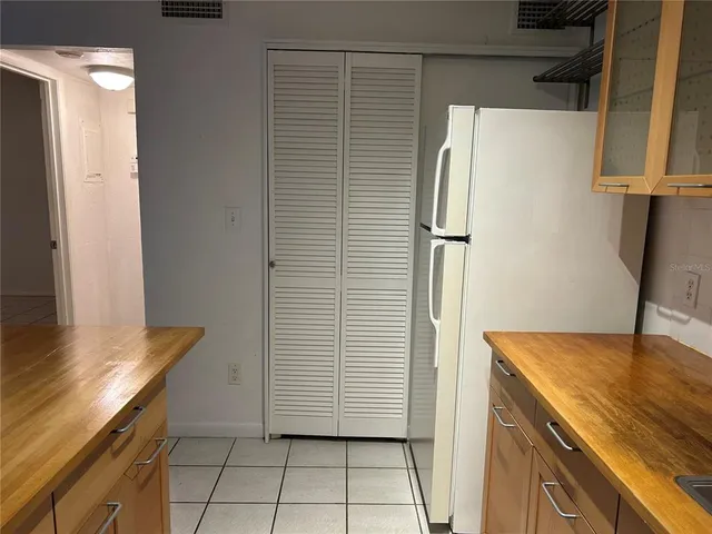 a kitchen with a sink a stove and cabinets
