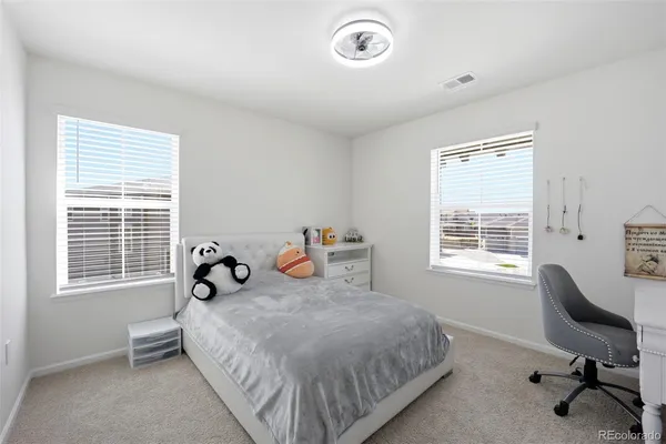 a bedroom with a bed and a desk