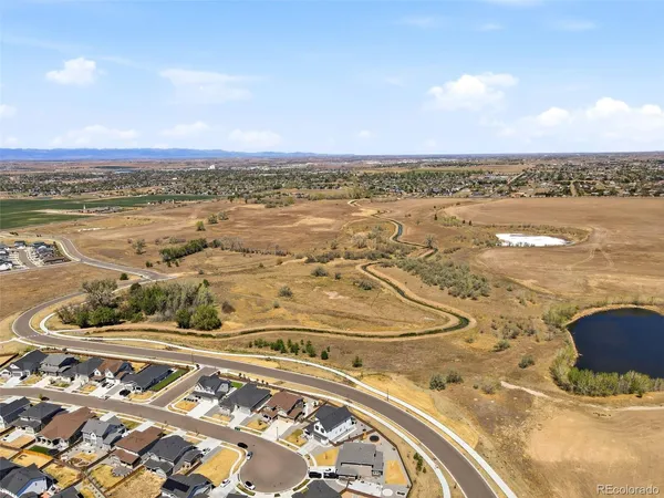an aerial view of residential houses with outdoor space and ocean view
