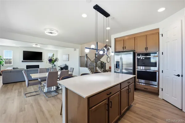 a kitchen with stainless steel appliances granite countertop a kitchen island a stove and a refrigerator