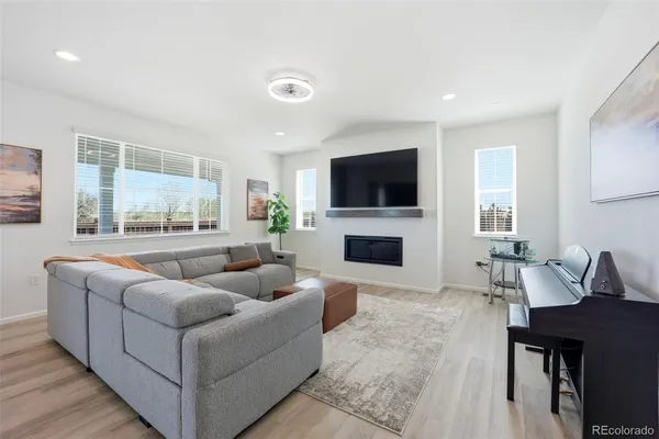 a living room with furniture a fireplace and a flat screen tv