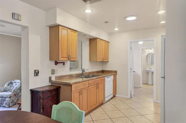 a kitchen with refrigerator cabinets and a sink