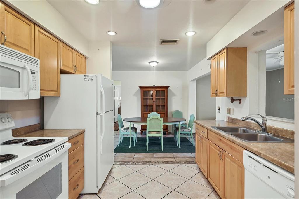 3621 Glen Ridge Lane Sarasota, FL 34233 - Photo 17 of 36 a kitchen with refrigerator cabinets and a sink