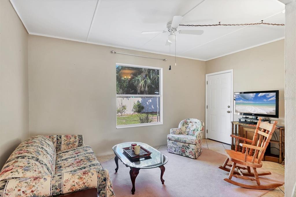 3621 Glen Ridge Lane Sarasota, FL 34233 - Photo 18 of 36 a living room with furniture a air conditioner and a window