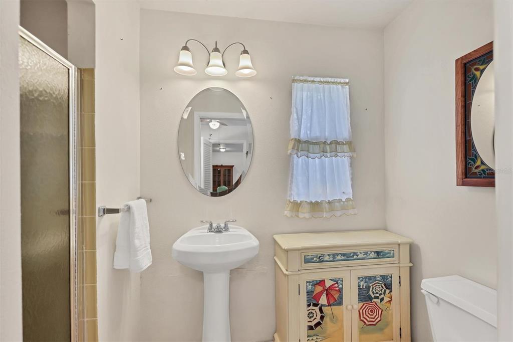 3621 Glen Ridge Lane Sarasota, FL 34233 - Photo 23 of 36 a bathroom with a sink and a mirror