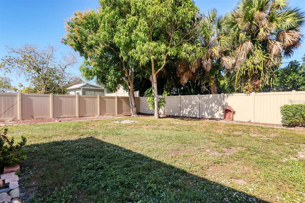 3621 Glen Ridge Lane Sarasota, FL 34233 - Photo 27 of 36 a view of a backyard with large trees and wooden fence