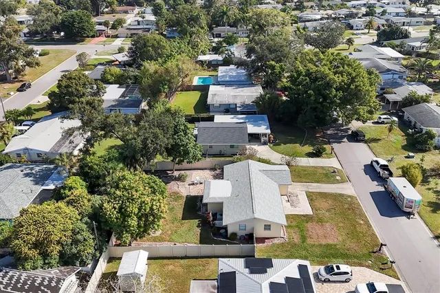 an aerial view of residential houses with outdoor space