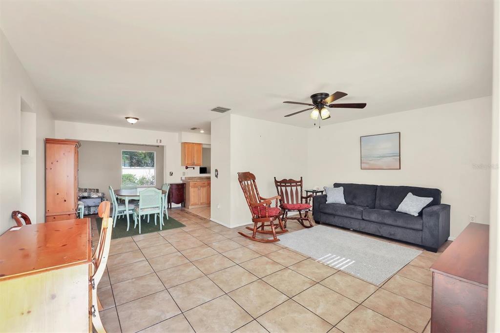 3621 Glen Ridge Lane Sarasota, FL 34233 - Photo 9 of 36 a living room with furniture a table and chairs
