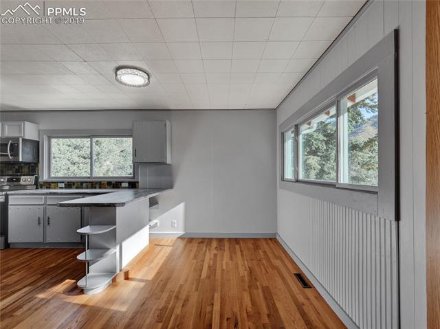 9915 Mesa Road Cascade, CO 80809 - Photo 7 of 25 Space for your dining table looking in to the newly redone kitchen, awesome views to enjoy while your sitting down to dinner with family