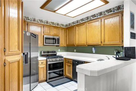 a kitchen with a sink a microwave a stove and refrigerator