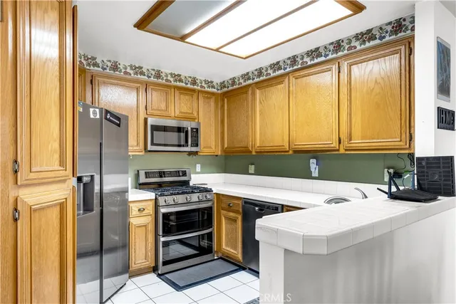 a kitchen with a sink a microwave a stove and refrigerator