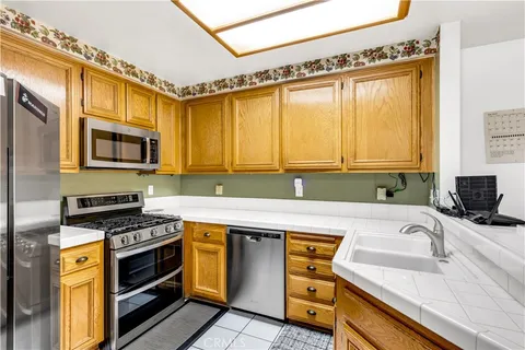 a kitchen with a sink a stove and cabinets