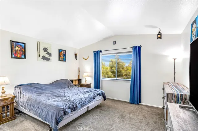 a bedroom with a large bed and a window