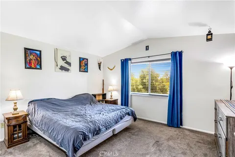 a bedroom with a large bed and a window