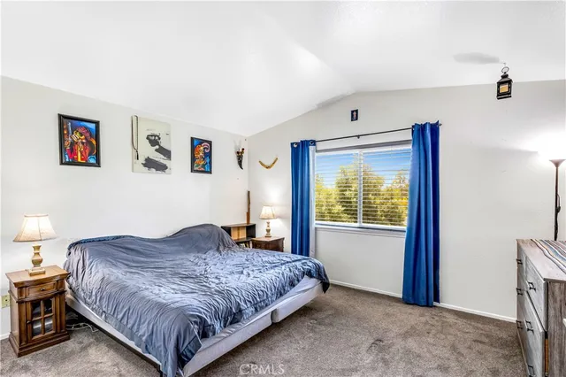 a bedroom with a large bed and a window